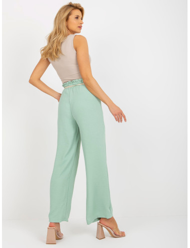 Light green fabric swedes pants with thin belt  