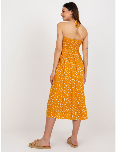Yellow summer dress with polka dots tied around the neck 